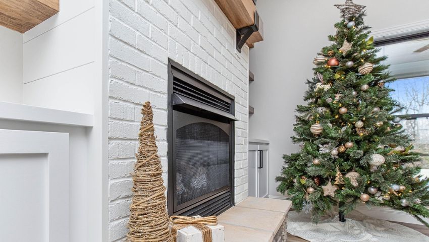 Contemporary living room with fireplace and decorated Christmas tree, combination of design and festive atmosphere